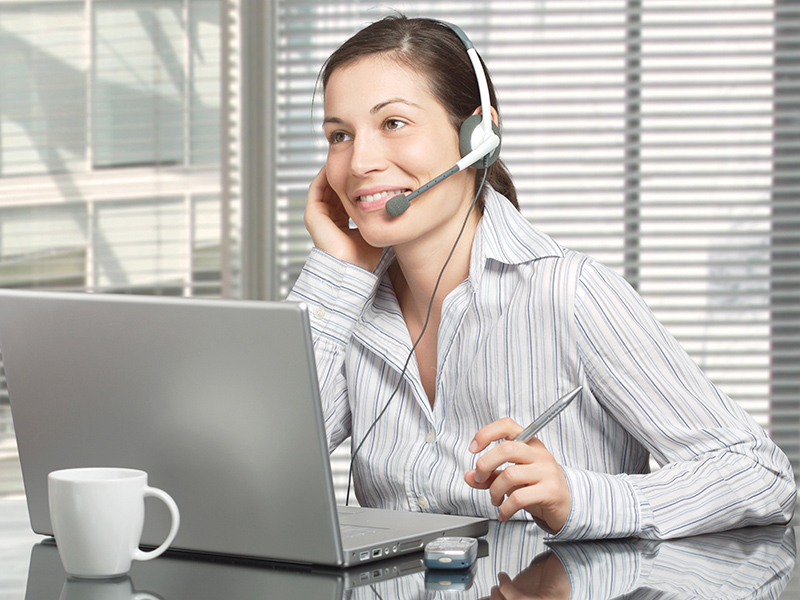 Person using headset and computer Person using headset and computer